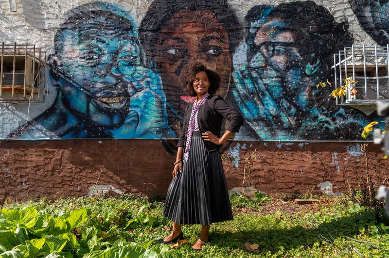 Marddy's Founder Keitra Bates Standing in front of a mural