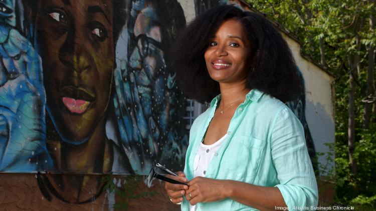 Marddy's founder Keitra Bates Standing in front of a mural